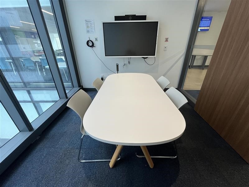 Small meeting room with table, chairs & screen