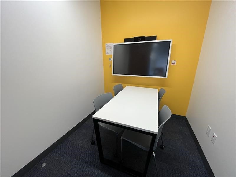 Small meeting room with table, chairs & screen