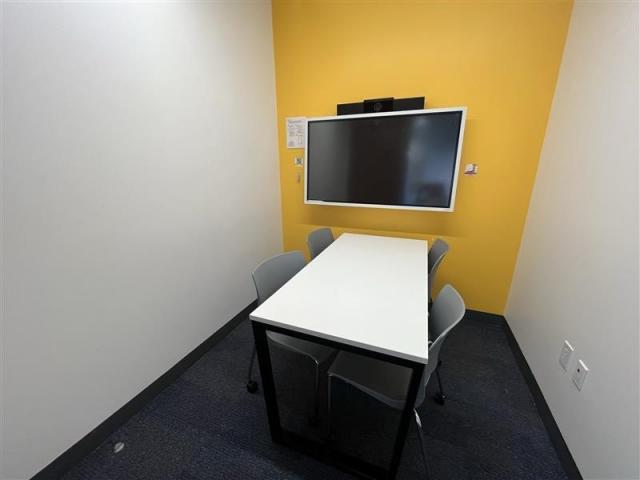 Small meeting room with table, chairs & screen