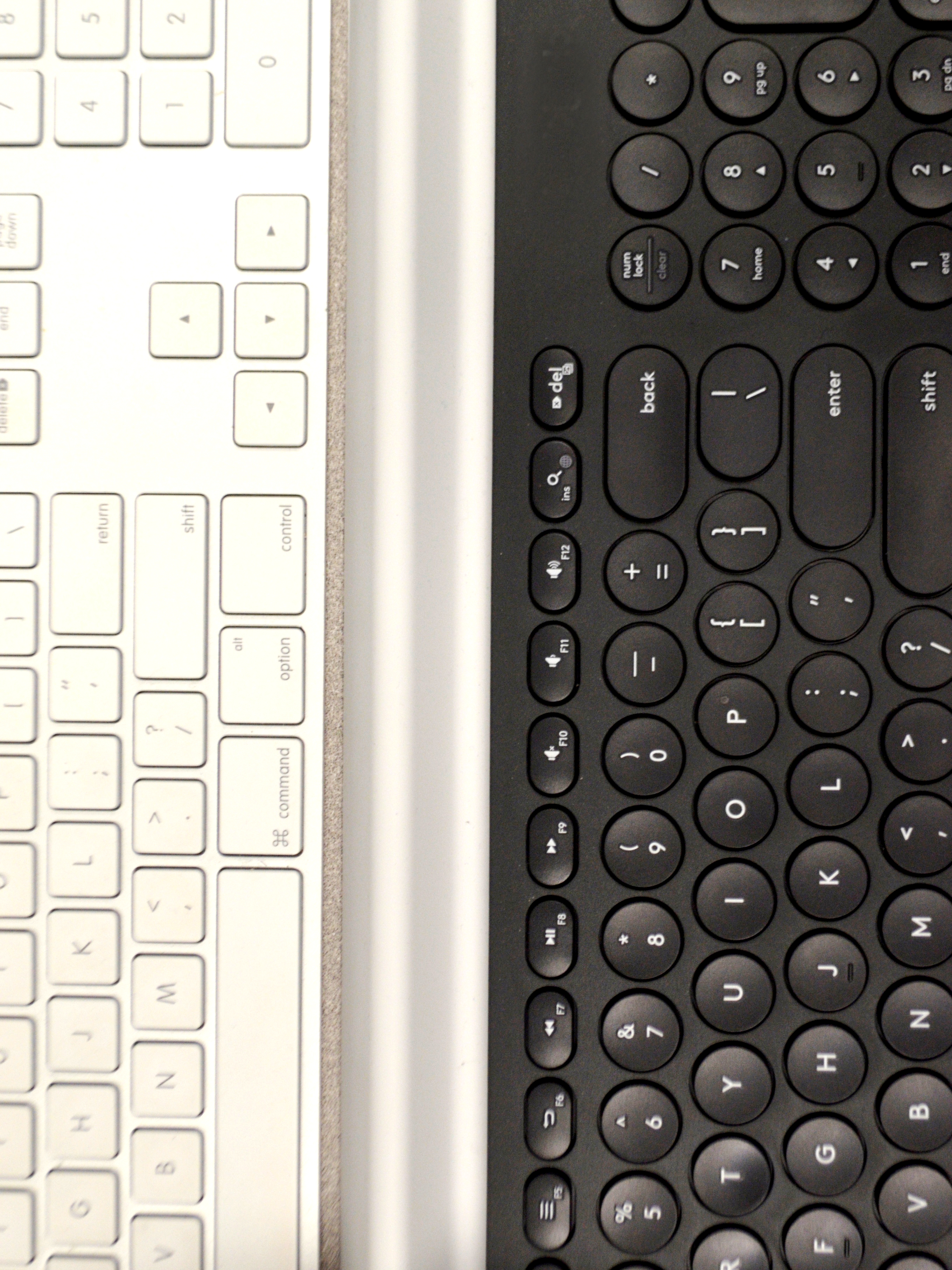 an overhead view of a white keyboard and a black keyboard. credit:Anne Zbitnew
