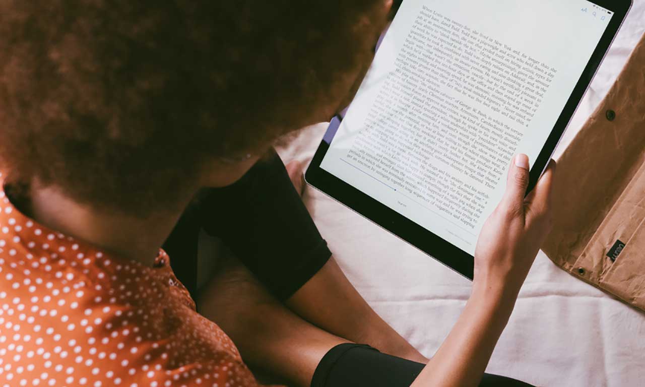 Overhead view of a person reading an e-book.