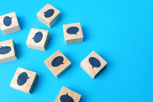Wooden blocks with speech bubbles on them